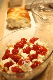 Spread some cream cheese and jam in the middle of the bowl of torn challah pieces.