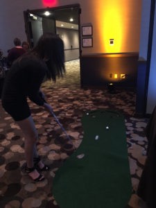 Anna Wert takes on the putting green at the Sabes JCC annual benefit