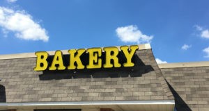 The iconic sign still hangs above the It Takes The Cake storefront.