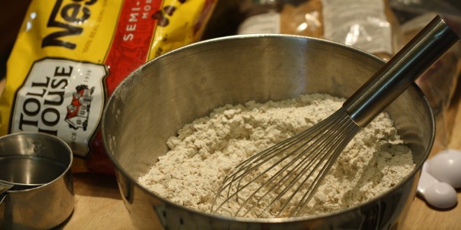 I like to use a whisk to get some air into the flour, but a sifter can do the same job.