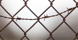 Chainlink fence with barbed wire.