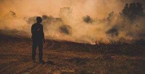 Firefighter surveys smoldering land in Israel.