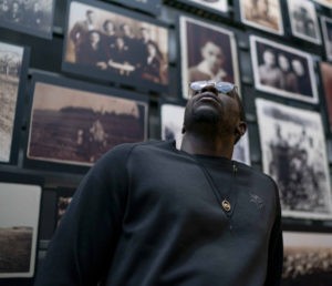 Stephen Weatherly looks up at the Tower of Faces at the Holocaust Museum. (Photo Courtesy the Minnesota Vikings).