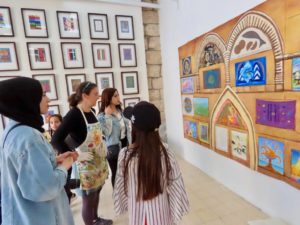 Aimee Orkin (center) views Interfaith Prayer Wall at the Kol Ha’Ot Art Gallery in Jerusalem. The architectural mural is now on display at University of St. Thomas' Hoedeman Gallery of Art through April. It includes the artistic work of women who are Jewish, Christian and Muslim. Photo courtesy of Aimee Orkin