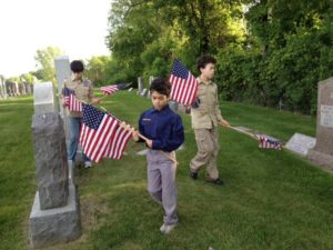 Scouts planting flags at cemetery in 2012