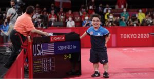 Ian Seidenfeld at the scoreboard after winning the gold medal at the Paralympic Games in Tokyo. (Photo courtesy Ian Seidenfeld. Photo by Cheng Howe Seet/ITTF)