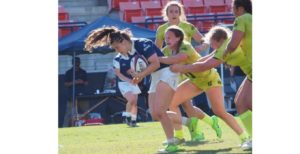 Ellie Fromstein (with the ball) drags would-be tacklers. She is competing for Team USA at the Maccabiah Games.