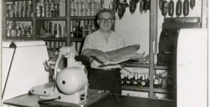 Ben Brochin holding up a large fish in his delicatessen in Northside Minneapolis, Minnesota, in 1950. (Photo courtesy the Brochin Family via University of Minnesota Libraries/Berman Upper Midwest Jewish Archives).
