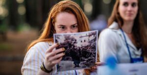 Madeline Jack looks at a photo from the 1940s during her group discussion at the Experience Israel 2023 Yom Ha'Shoah commemoration. (Photo by Ethan Roberts Photography)