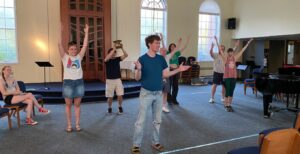 The cast of the Minnesota Fringe show "Extreme Roadshow" rehearses at Shir Tikvah.