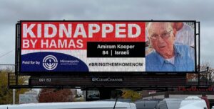 A digital billboard shows the name, photo, and age of Amiram Kooper, who was kidnapped by Hamas during its Oct. 7 attack on Israel.