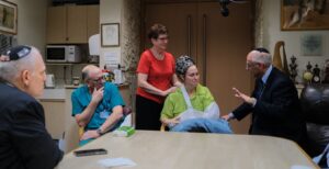 Rabbi Harold Kravitz (left) offering a prayer for healing to Michal a nurse from Hadassah Hospital who was separated from her husband and children while assisting a wounded woman soldier who survived. Michal was shot at point blank, once in the chest and three times in the arm. She was left for dead but she survived. Doctors at Haddasah have saved her arm. (Photo courtesy Conference of Presidents).