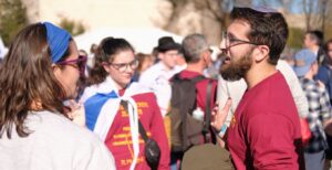 Beth El Synagogue Associate Rabbi Matt Goldberg (R) talks to a march participant. (Photo by Lev Gringauz/TC Jewfolk).