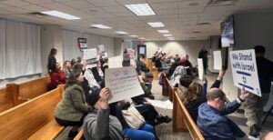 A crowd of people both for and against the Minneapolis City Council's ceasefire resolution at the Thursday, Jan. 25 meeting.