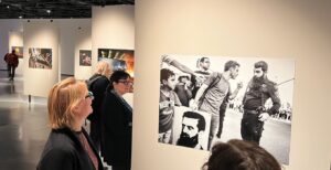 Danna Wohlfeiler-Lalkin shows photos at the Local Testimony 2023 exhibition at the Eretz Museum in Tel Aviv. (Photo by Lonny Goldsmith/TC Jewfolk).