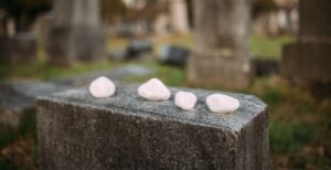 Gravestone with stones on it. (Photo by Ivan Radic/Creative Commons)