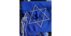 a blue graduation cap with a rhinestone star of David on it.