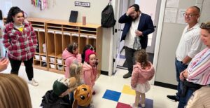 Rabbi Sholom Brook, with guests Colin and Wendy Smith, visit a class before hanging mezuzot in the new building in Spring 2024. (Lonny Goldsmith/TC Jewfolk)