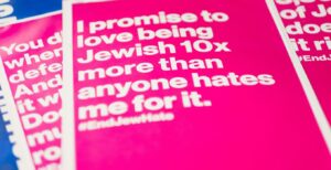 JewBelong posters at a march against antisemitism. (Photo by Levi Meir Clancy/Unsplash)