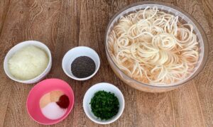 Ingredient prep for the latkes, from left: onions, seasoning, chia seeds, parsely, spiralized potato. (Photo by Nikki Gordon)