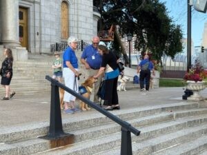 Mount Zion Cantor Rachel Spilker pets a therapy dog, one of several outside the Basilica of St. Mary, that were brought by Lutheran Church Charities to help mourners. (Lonny Goldsmith/TC Jewfolk).