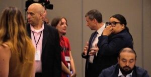 DNC Chairman Ken Martin (second right) talks with Allison Minnerly after her Resolution for Gaza failed to pass at the DNC Resolution Committee. (Lonny Goldsmith/TC Jewfolk).
