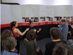 Michal Rottenberg giving a tour of "Through Their Eyes" exhibit on Sept. 26, 2025. (Lonny Goldsmith/TC Jewfolk).