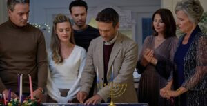 Lighting the menorah in "Oy to The World" on The Hallmark Channel. (Courtesy The Hallmark Channel).