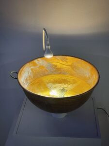 Rachel Cohn's "Air Becomes Water," an etched copper bowl and radio, made in 2026 in collaboration with Natan Diacon-Furtado.