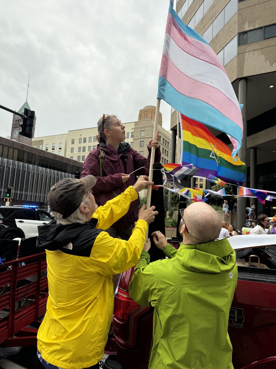 From left: Paul Koester, Rabbi Jayce Koester and Zach put flags on the truck for the Pride Parade.