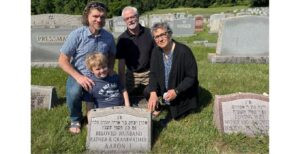 Vicki Schmidt, her husband, her son, and her grandson visiting the grave of Vicki’s father for the first time.